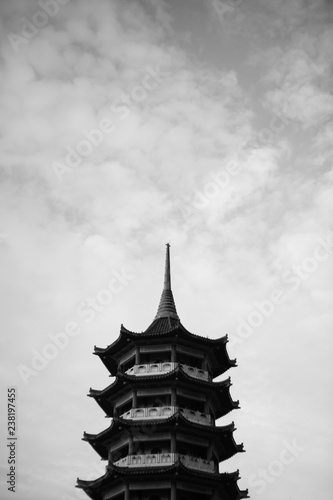 Pagoda tower with dramatic cloud black and white