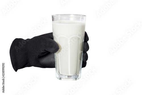 gloved hand holding a glass of milk on an isolated white background photo