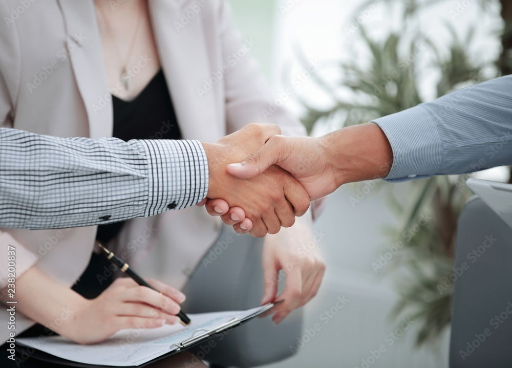 closeup.handshake financial partners on the background of the office closeup.handshake financial partners on the background of the office