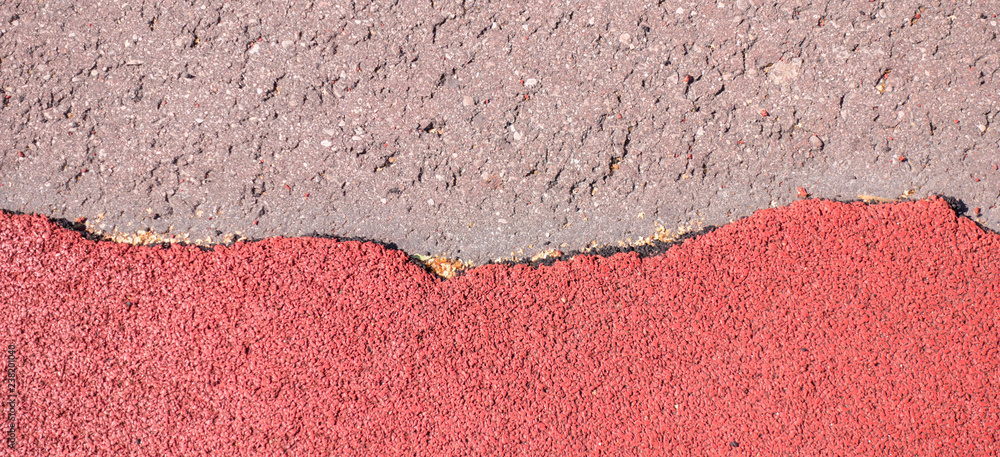 Fototapeta premium Old torn red rubber crumb cover, treadmill or running track surface outdoor playground stadium texture background.