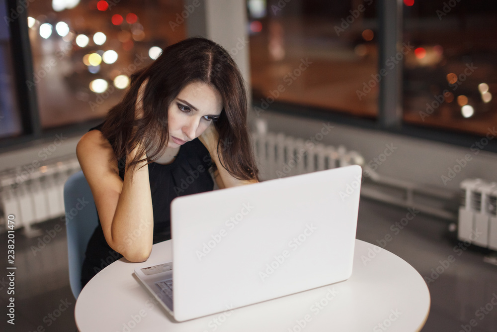 Businesswoman working at the table with a desk lamp. Businesswoman working at the table with a desk lamp.