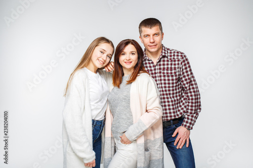 Young smiling girl with her parents. Young family
