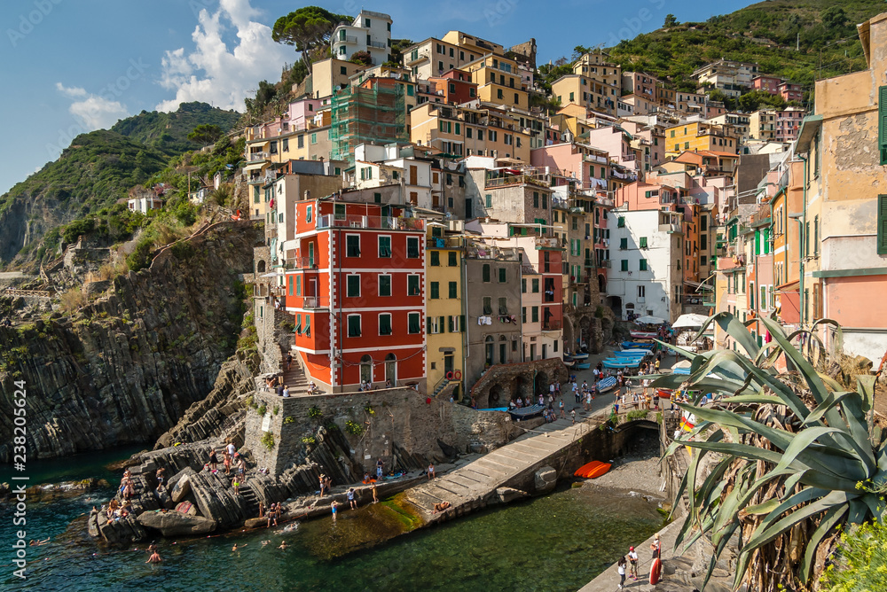 Riomaggiore -one of the most beautiful places in Italy. An amazing place with mountains and sea.Featuring with green terraces, colorful houses with bright colors, and hills with vines and fruit trees.