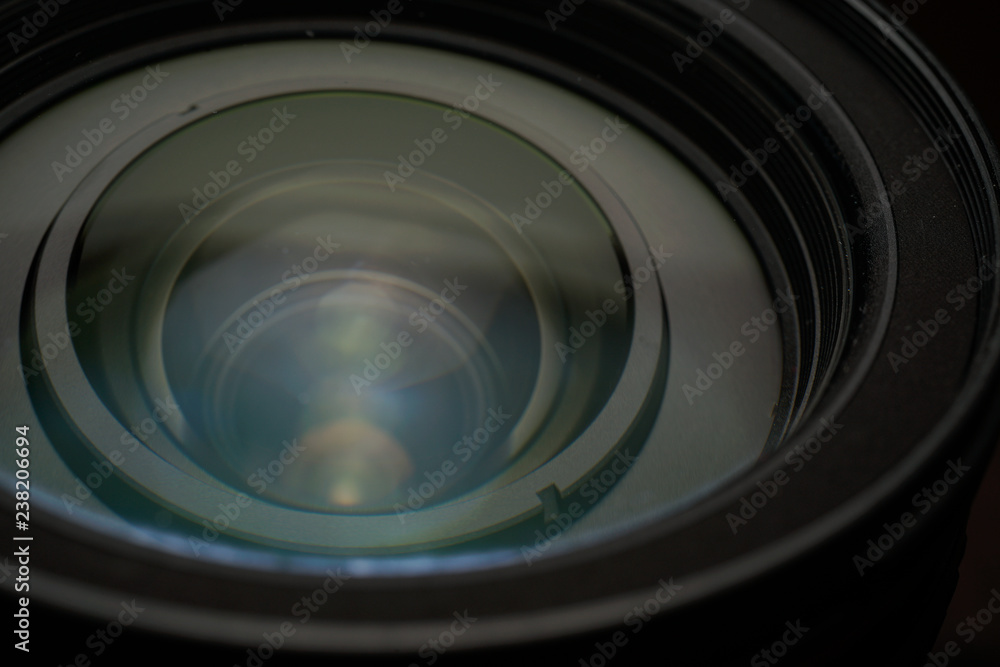 Close up of modern digital camera lense, a view of the front lens with flare effects