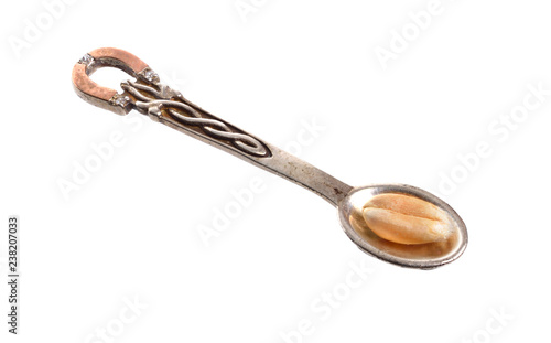 Petit silver jewelery spoon with one wheat grain. Isolated on white background
