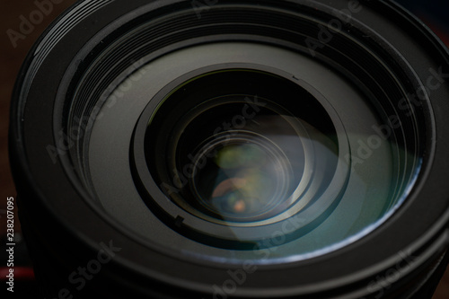 Close up of modern digital camera lense, a view of the front lens with flare effects