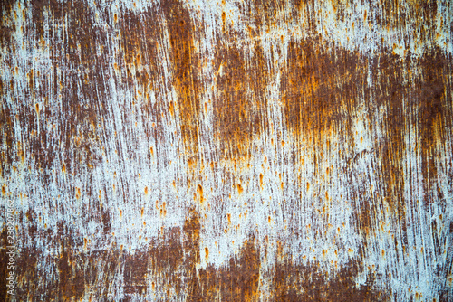 Grunge texture with a deep pattern. White brushstrokes over brown background