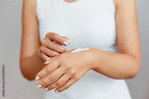 Hand Skin Care. Close Up Of Female Hands Holding Cream Tube  Beautiful Woman Hands With Natural Manicure Nails Applying Cosmetic Hand Cream On Soft Silky Healthy Skin. Beauty And Body Care Concept