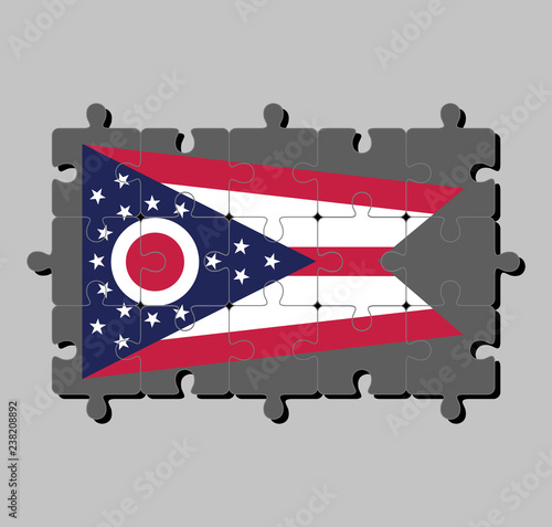 Jigsaw puzzle of Ohio flag in Guidon consisting of 5 horizontal stripes alternating between red and white. The chevron is azure containing a white and red 