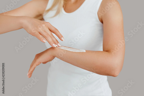 Wallpaper Mural Closeup shot of woman hands holding cream and applying moisturizing hand cream. Beautiful female hands with cream. Hand Skin Care. A woman uses body lotion on your arms. Beauty And Body Care Concept Torontodigital.ca