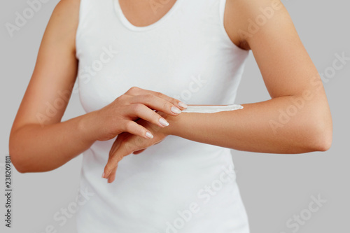 Wallpaper Mural Closeup shot of woman hands holding cream and applying moisturizing hand cream. Beautiful female hands with cream. Hand Skin Care. A woman uses body lotion on your arms. Beauty And Body Care Concept Torontodigital.ca