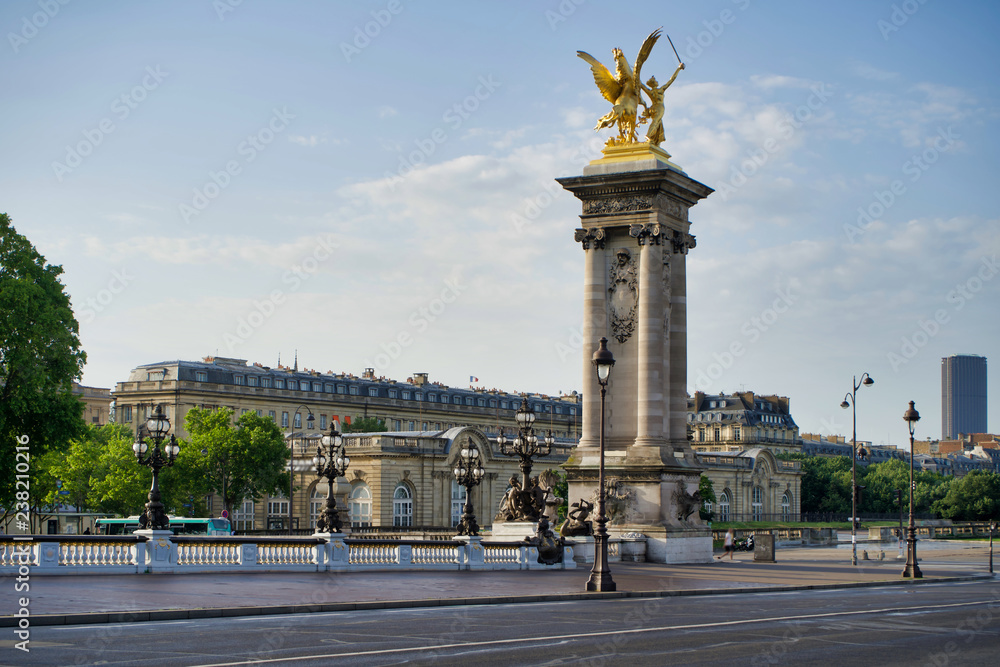 PARIS, FRANCE - MAY 26, 2018: Columns with statues on Pont Alexandre III