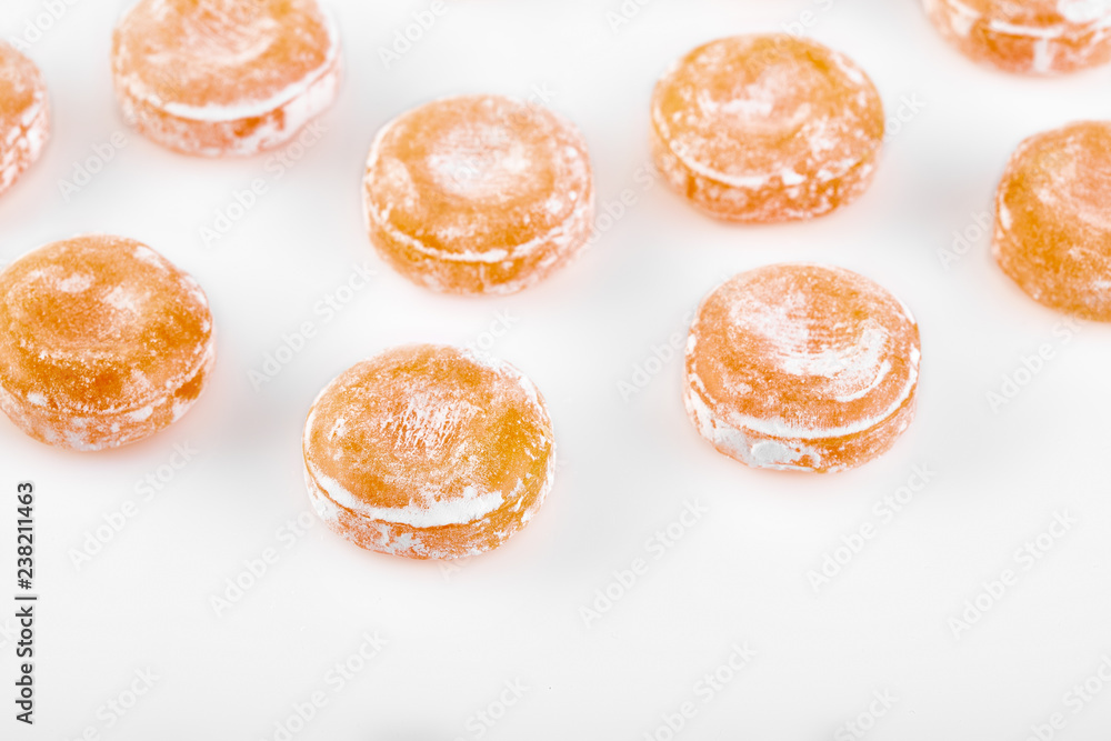 Colored round candy in powdered sugar. Bright candy.