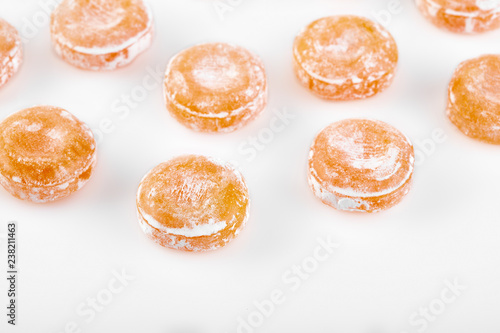 Colored round candy in powdered sugar. Bright candy.