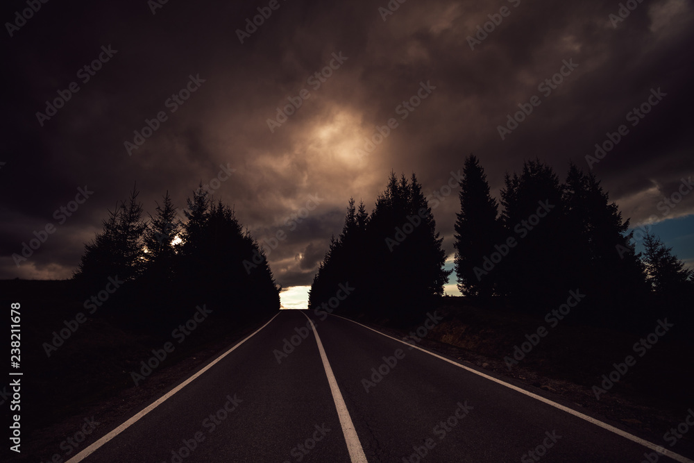 Threatening dark clouds showing over a strech of road Threatening dark clouds showing over a strech of road