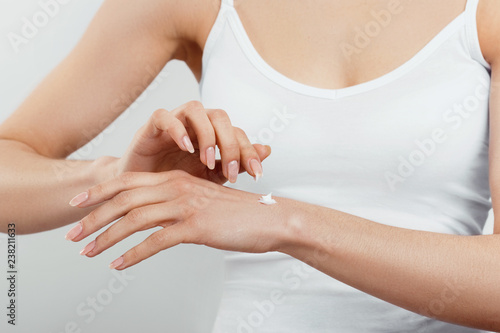 Hand Skin Care. Women use body lotion on your arms. Female applying cream to her hands