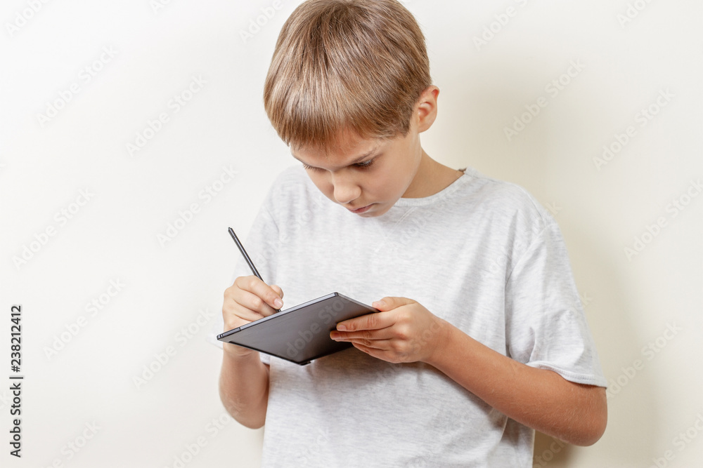 Kid drawing with graphic tablet and stylus pen Kid drawing with graphic tablet and stylus pen