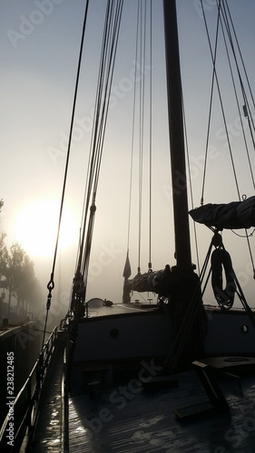 Sailboat moored on a foggy morning in Harlingen