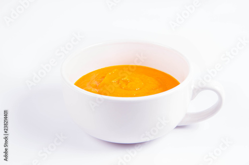 Pumpkin soup in a bowl on a white background