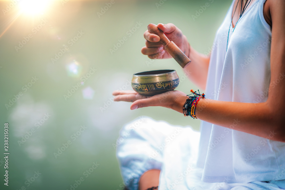 Young woman with Tibetan Singing Bowl - obrazy, fototapety, plakaty 