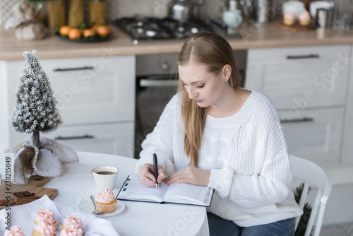 Canvas Print Portrait of a girl writing notes to notebook.