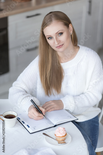 Portrait of a girl recording in a notebook.
