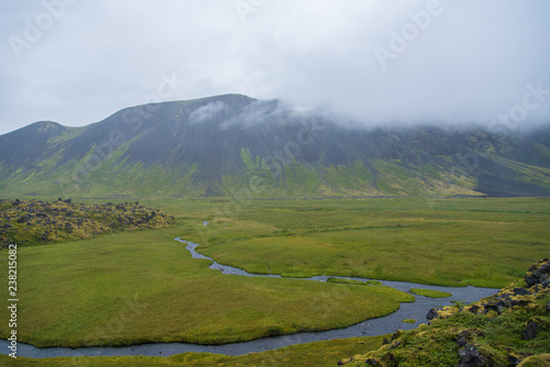 A river snakes through a wide valley on Iceland's Hornstrandir Peninsula photo