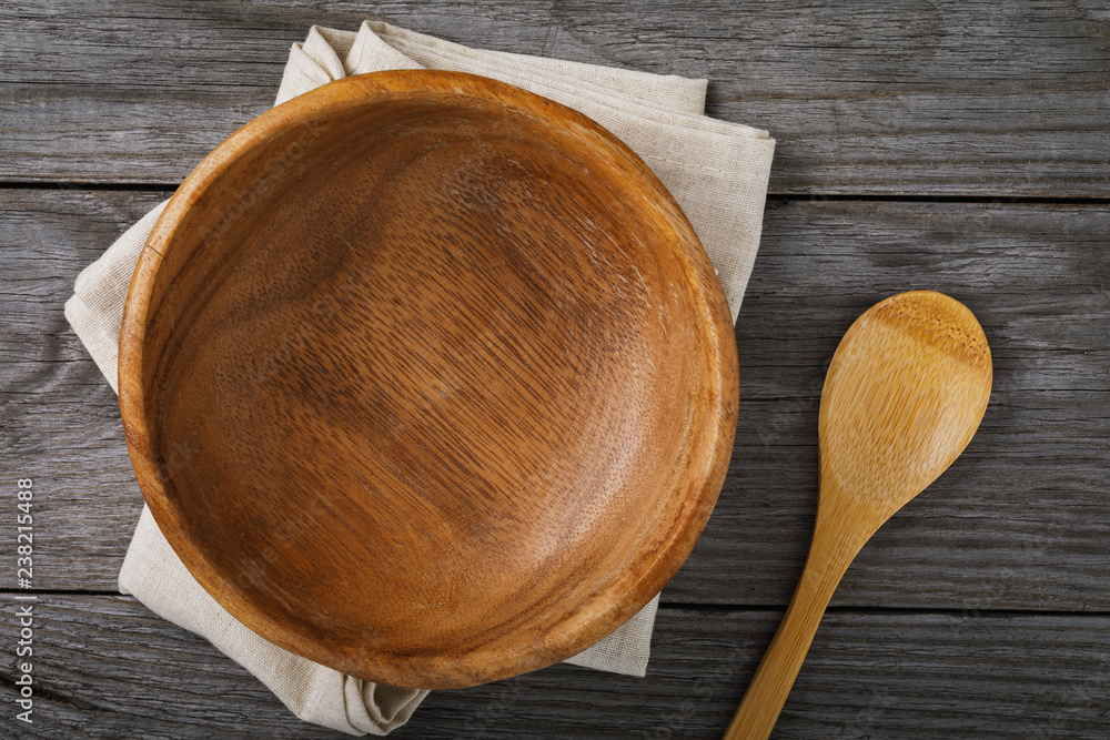 Empty wooden plate with a spoon on the table, top view Empty wooden plate with a spoon on the table, top view
