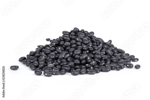 Lot of whole raw black turtle beans stack isolated on white background