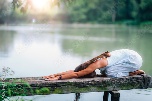 Yoga Woman by The Lake. Balasana photo