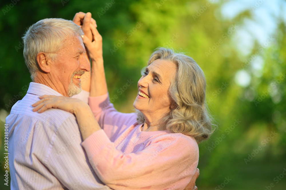 Portrait of cute happy senior couple dancing