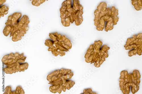 Pattern of walnuts on the white background. Diet and culinary concept. Top view, flat lay