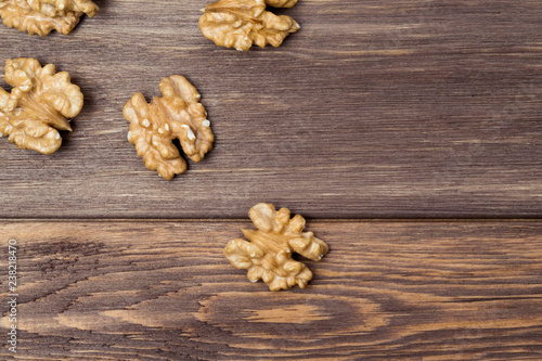 Walnuts on the wooden background. Diet and culinary concept. Top view, flat lay, copy space