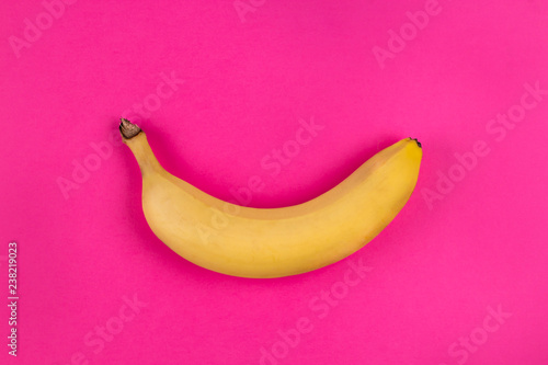 Banana on the pink background. Minimalistic fashion design, bright trendy colors. Copy space, top view, flat lay