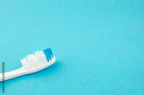 Toothbrushes on blue background. Copy space for text