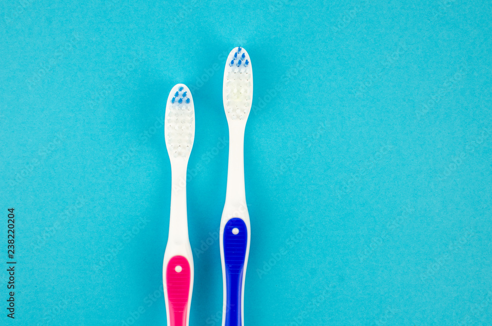 Toothbrushes on blue background. Copy space for text Toothbrushes on blue background. Copy space for text
