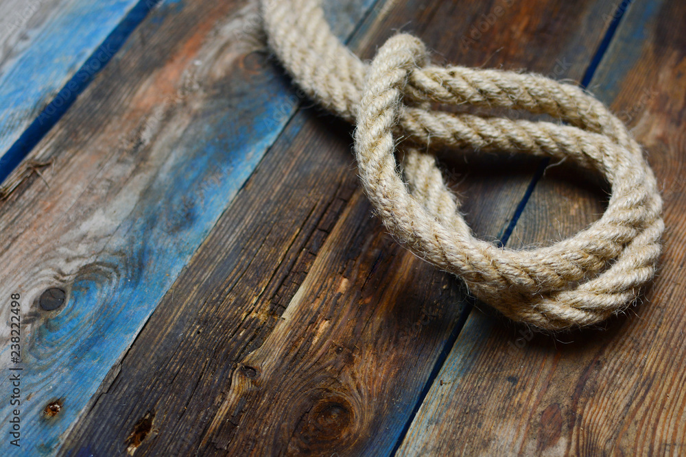 Rope loop. Noose closeup.  Nautical rope knot on a weathered wooden desk