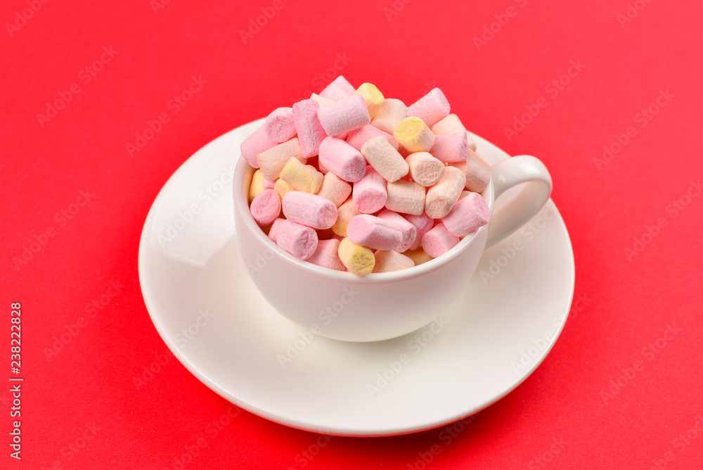 Cup with marshmallow on a red background. Copy space. Cup with marshmallow on a red background. Copy space.
