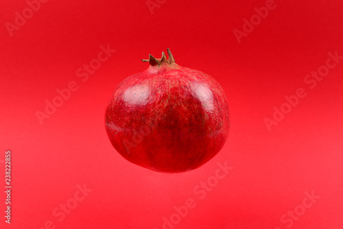 Pomegranate on a red background.