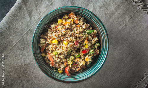 Quinoa salad bowl with various vegetables: green beans, carrot, corn, bell pepper, peas. Top view, copy space..Quinoa is gluten-free, high in protein and contains all nine essential amino acids.