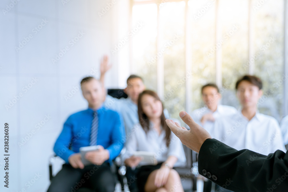 Employees are the questions ask during the meeting, the plan of the company , picture focus at hand of speaker Employees are the questions ask during the meeting, the plan of the company , picture focus at hand of speaker