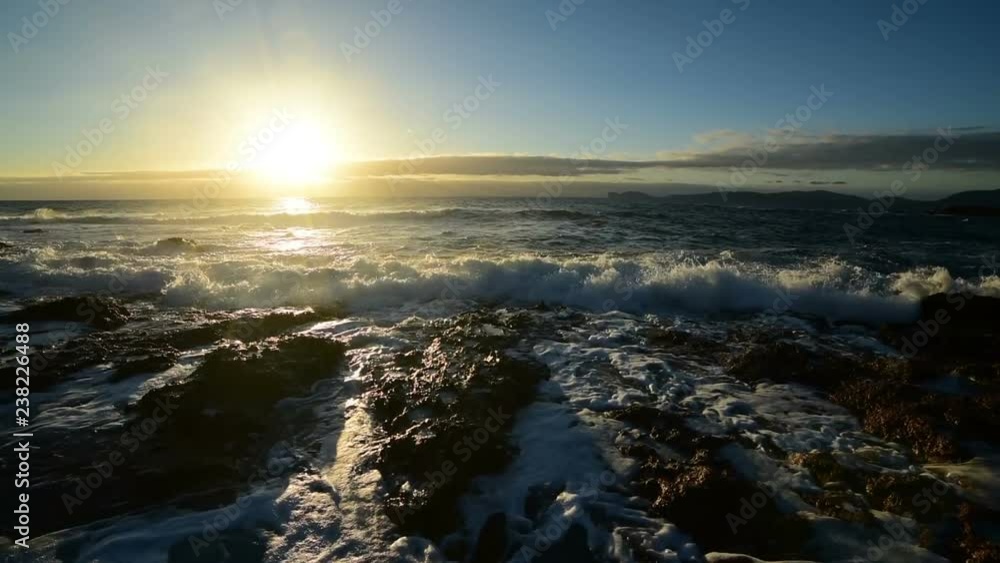 Waves on Alghero rocky shore at sunset. Sardinia, Italy Waves on Alghero rocky shore at sunset. Sardinia, Italy