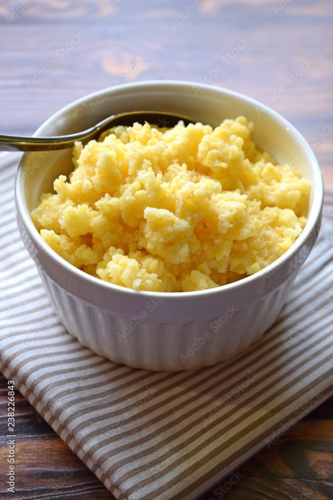 Useful cornmeal porridge on wooden background. Useful cornmeal porridge on wooden background.
