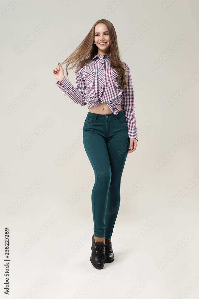Young girl in tight jeans posing in Studio Young girl in tight jeans posing in Studio