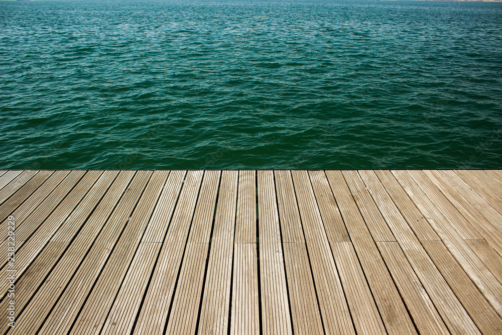 wooden deck floor surface waterfront perspective background texture and sea vivid blue water, copy space - obrazy, fototapety, plakaty 