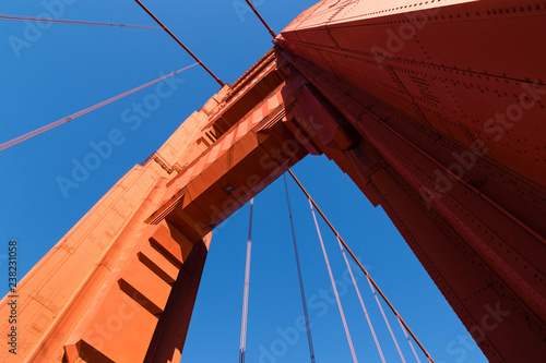 Golden Gate Bridge, San Francisco, California, tower against a bright blue sky looking up
