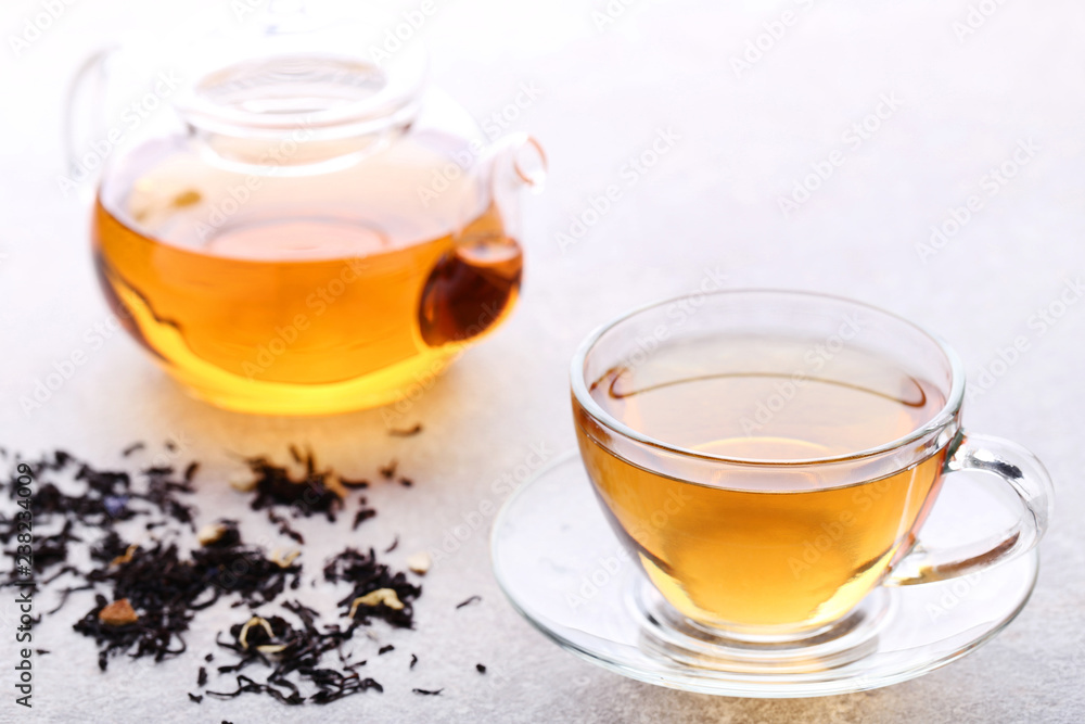 Cup of tea with dry leafs and teapot Cup of tea with dry leafs and teapot