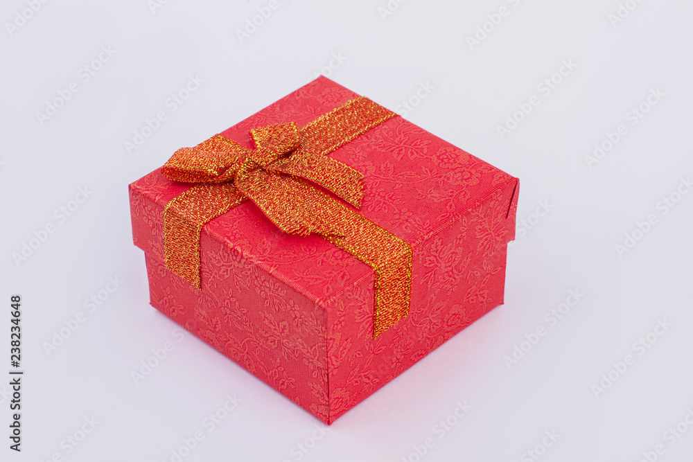 Luxury red gift box isolated. Small jewelry present box with golden bow. Holiday greeting concept. Luxury red gift box isolated. Small jewelry present box with golden bow. Holiday greeting concept.