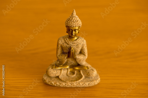 The figure of a Buddha meditating on a table