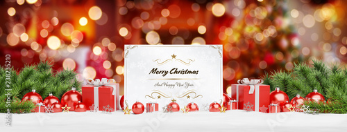Christmas card laying on red baubles and gift d 3D rendering